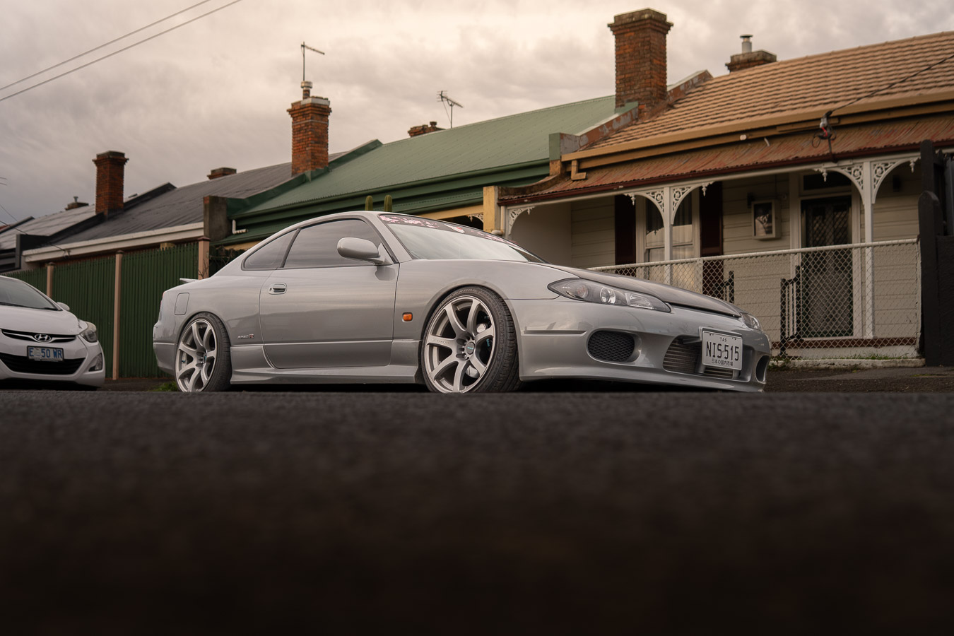 Silver Nissan Silvia S15 parked on a street of heritage cottages